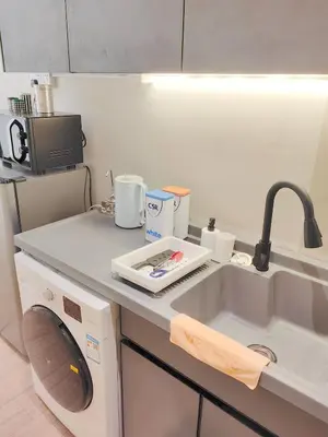a kitchen counter with a sink and a microwave at The Ovation - Bangsar Trade Centre in Kuala Lumpur