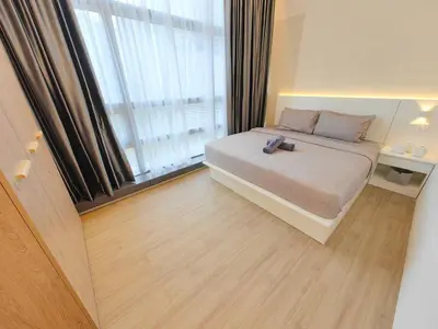 a bedroom with a bed and a large window at The Ovation - Bangsar Trade Centre in Kuala Lumpur