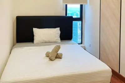 a stuffed animal sitting on top of a bed at Arte Mont Kiara_Publika_Solaris in Kuala Lumpur