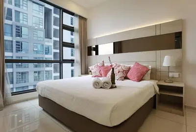 a bedroom with a large bed with pink pillows at MyCrib19*The Robertson KL - Bukit Bintang Pavilion in Kuala Lumpur