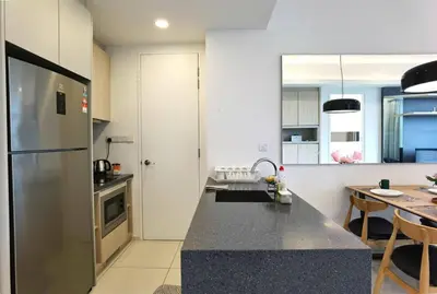 a kitchen with a stainless steel refrigerator and a table at MyCrib19*The Robertson KL - Bukit Bintang Pavilion in Kuala Lumpur