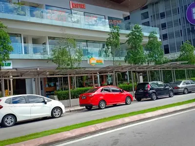 a row of parked cars parked in front of a building at MyCrib19*The Robertson KL - Bukit Bintang Pavilion in Kuala Lumpur