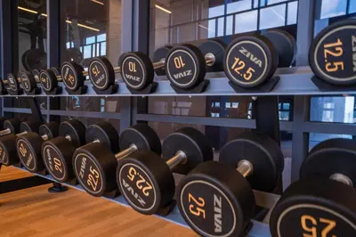 a bunch of dumbbells on display in a gym at Societe Hartamas in Kuala Lumpur