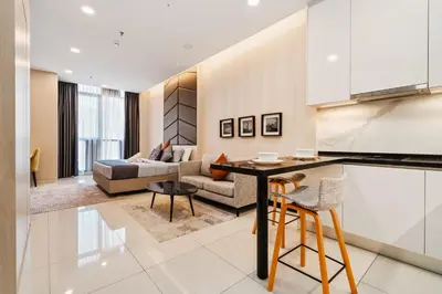 a kitchen and living room with a couch at Societe Hartamas in Kuala Lumpur