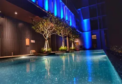 an indoor swimming pool with trees in a building at Expressionz Kuala Lumpur in Kuala Lumpur