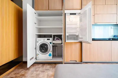 a kitchen with a washer and dryer in a closet at Expressionz Kuala Lumpur in Kuala Lumpur
