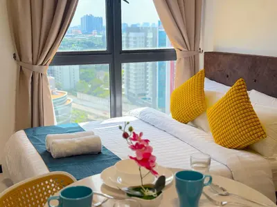 a room with a bed with a table and a window at Neu Suites By Serenity Homes Near Gleneagles, KLCC & LRT in Kuala Lumpur
