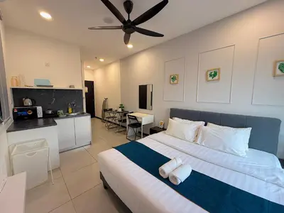 a bedroom with a large bed and a kitchen at Neu Suites By Serenity Homes Near Gleneagles, KLCC & LRT in Kuala Lumpur
