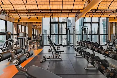 a gym with rows of treadmills and machines at Scarletz Suites Klcc by Signature Apartment in Kuala Lumpur