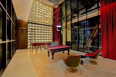 a room with a ping pong table and chairs at Scarletz Suites Klcc by Signature Apartment in Kuala Lumpur