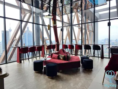 a room with a couch and chairs in a building at Scarletz Suites Klcc by Signature Apartment in Kuala Lumpur