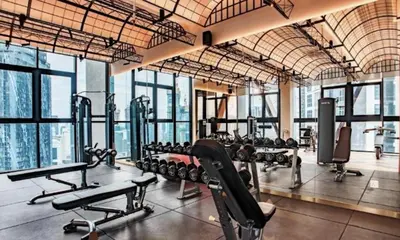 a gym with a lot of treadmills and machines at Scarletz Suites Klcc by Signature Apartment in Kuala Lumpur