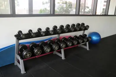 a rack of dumbbells in a gym at Lucentia Global Signature Suites Kuala Lumpur in Kuala Lumpur