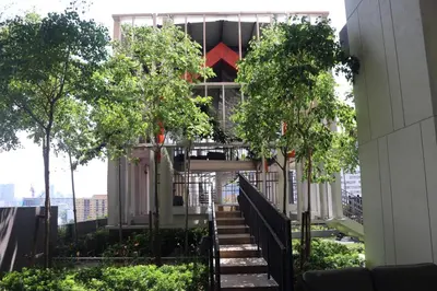 a staircase leading up to a building with trees at Lucentia Global Signature Suites Kuala Lumpur in Kuala Lumpur