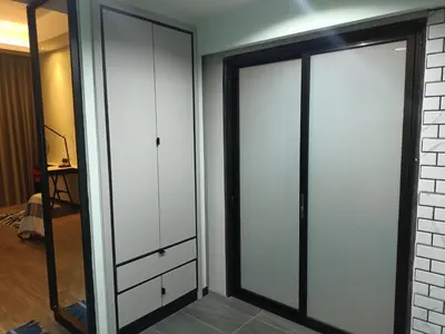 a closet with white cabinets and a mirror at James' Studio unit Maison 101 at Heritage Row, Kuala Lumpur in Kuala Lumpur