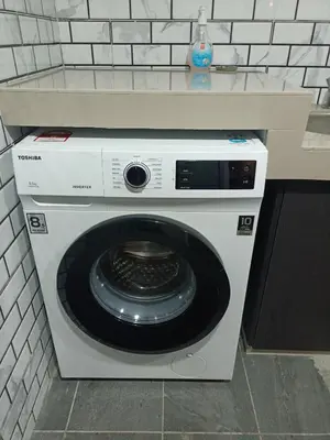 a washing machine in a kitchen with a counter at James' Studio unit Maison 101 at Heritage Row, Kuala Lumpur in Kuala Lumpur