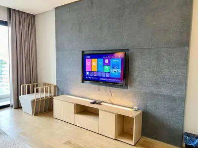 a living room with a flat screen tv on a wall at 188 suites 2bedroom/4pax/13minute walk to klcc in Kuala Lumpur