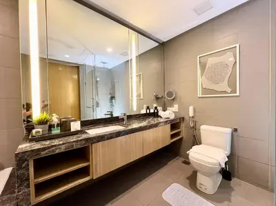 a bathroom with a toilet and a large mirror at 188 suites 2bedroom/4pax/13minute walk to klcc in Kuala Lumpur