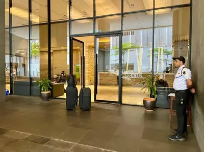 a police officer standing in the lobby of a building at 188 suites 2bedroom/4pax/13minute walk to klcc in Kuala Lumpur