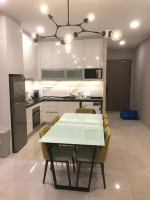a kitchen with a white table and some chairs at M and S Suite at Societe Suites Sri Hartamas, Mont Kiara in Kuala Lumpur