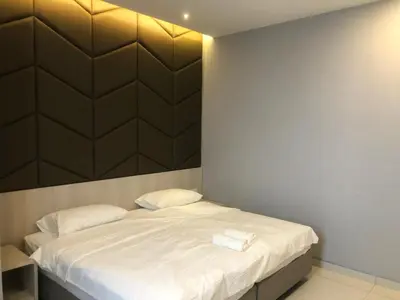 a bedroom with a bed with two towels on it at M and S Suite at Societe Suites Sri Hartamas, Mont Kiara in Kuala Lumpur
