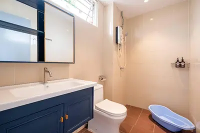 a bathroom with a sink and a toilet and a window at RetroJazz Kids House 15pax 4Room in Kuala Lumpur
