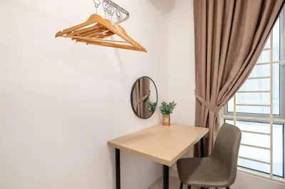 a desk and chair in a room with a window at RetroJazz Kids House 15pax 4Room in Kuala Lumpur