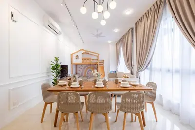 a dining room with a wooden table and chairs at Kids Wonderland opposite MyTown near TRX Mall MRT in Kuala Lumpur