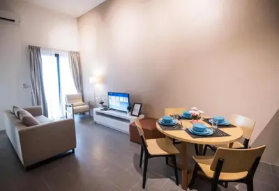 a living room with a table and chairs and a television at KL Sentral Bangsar Suites EST by Inam Suites in Kuala Lumpur