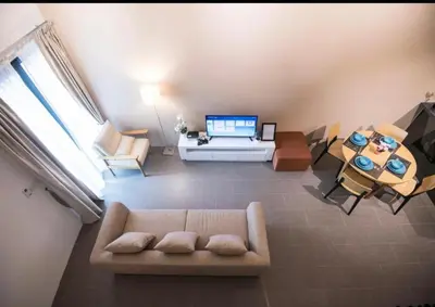a living room with a couch and a table at KL Sentral Bangsar Suites EST by Inam Suites in Kuala Lumpur