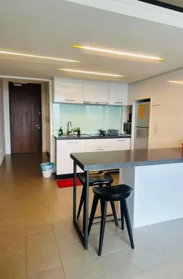 a kitchen with a table and two stools in it at KL Sentral Bangsar Suites EST by Inam Suites in Kuala Lumpur