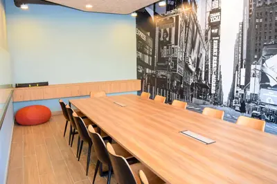 a conference room with a large wooden table and chairs at Neu Suites by Snugster 2 Bedroom, 3km to KLCC in Kuala Lumpur
