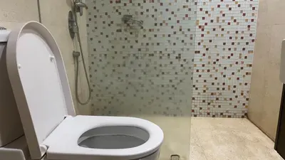 a bathroom with a toilet and a shower at Spritz Empire Regalia Suites & Residence in Kuala Lumpur