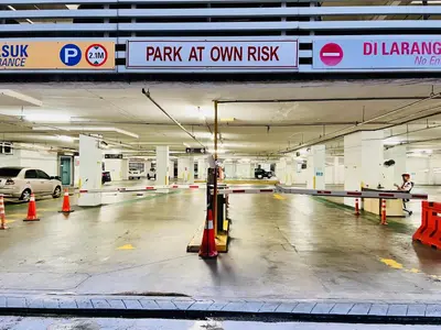 an empty parking garage with a car parked in it at Spritz Empire Regalia Suites & Residence in Kuala Lumpur
