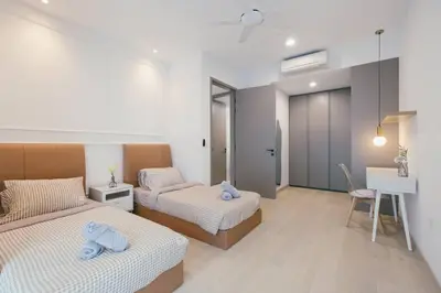 a bedroom with two beds with blue towels on them at NEW! Eaton Infinity SKY POOL KLCC view Pavilion in Kuala Lumpur