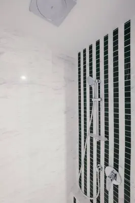 a bathroom with a shower with green and white tiles at NEW! Eaton Infinity SKY POOL KLCC view Pavilion in Kuala Lumpur