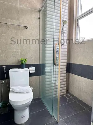 a bathroom with a toilet and a glass shower at 3BR 5-6Pax Zetapark Setapak Central Near Zoo in Kuala Lumpur