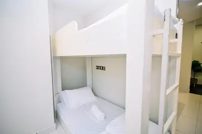 a white bunk bed in a white room at Swing & Pillows - Central Market Kuala Lumpur in Kuala Lumpur