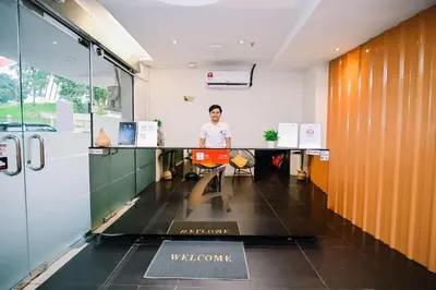 a person sitting at a desk in an office at Swing & Pillows - Central Market Kuala Lumpur in Kuala Lumpur