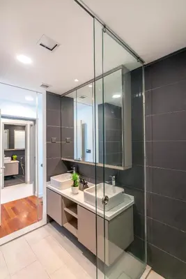 a bathroom with two sinks and a glass shower at Novo Ampang by COBNB near Gleneagles in Kuala Lumpur