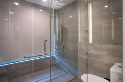 a bathroom with a glass shower with a toilet at Novo Ampang by COBNB near Gleneagles in Kuala Lumpur