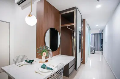 a dining room with a table and a mirror at Novo Ampang by COBNB near Gleneagles in Kuala Lumpur