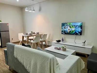 a living room with a couch and a tv on the wall at 30 OFF Monthly l 4Pax Designer Suite by CITYSPACE in Kuala Lumpur