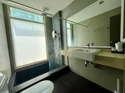 a bathroom with a sink and a toilet and a window at 30 OFF Monthly l 4Pax Designer Suite by CITYSPACE in Kuala Lumpur