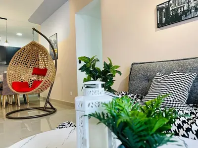 a living room with a couch and a table with plants at MVB49#8pax Family Suite 3 Rooms Velocity Mall IKEA in Kuala Lumpur