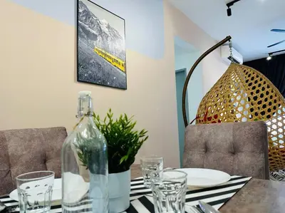 a table with a glass bottle on top of it at MVB49#8pax Family Suite 3 Rooms Velocity Mall IKEA in Kuala Lumpur