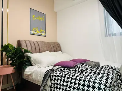 a bedroom with a bed with a black and white blanket at MVB49#8pax Family Suite 3 Rooms Velocity Mall IKEA in Kuala Lumpur