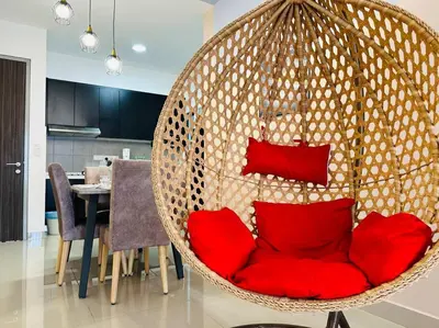 a hanging chair with red pillows in a living room at MVB49#8pax Family Suite 3 Rooms Velocity Mall IKEA in Kuala Lumpur