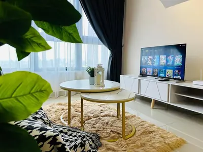 a living room with a table and a tv at MVB49#8pax Family Suite 3 Rooms Velocity Mall IKEA in Kuala Lumpur