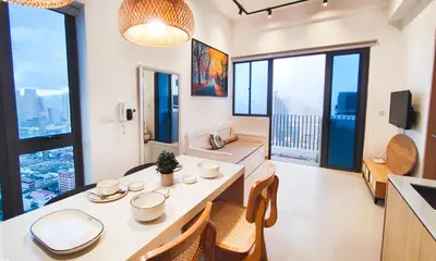 a living room with a table and chairs and large windows at CL24A 5-6pax KLCC Sky Pool Condo in Kuala Lumpur